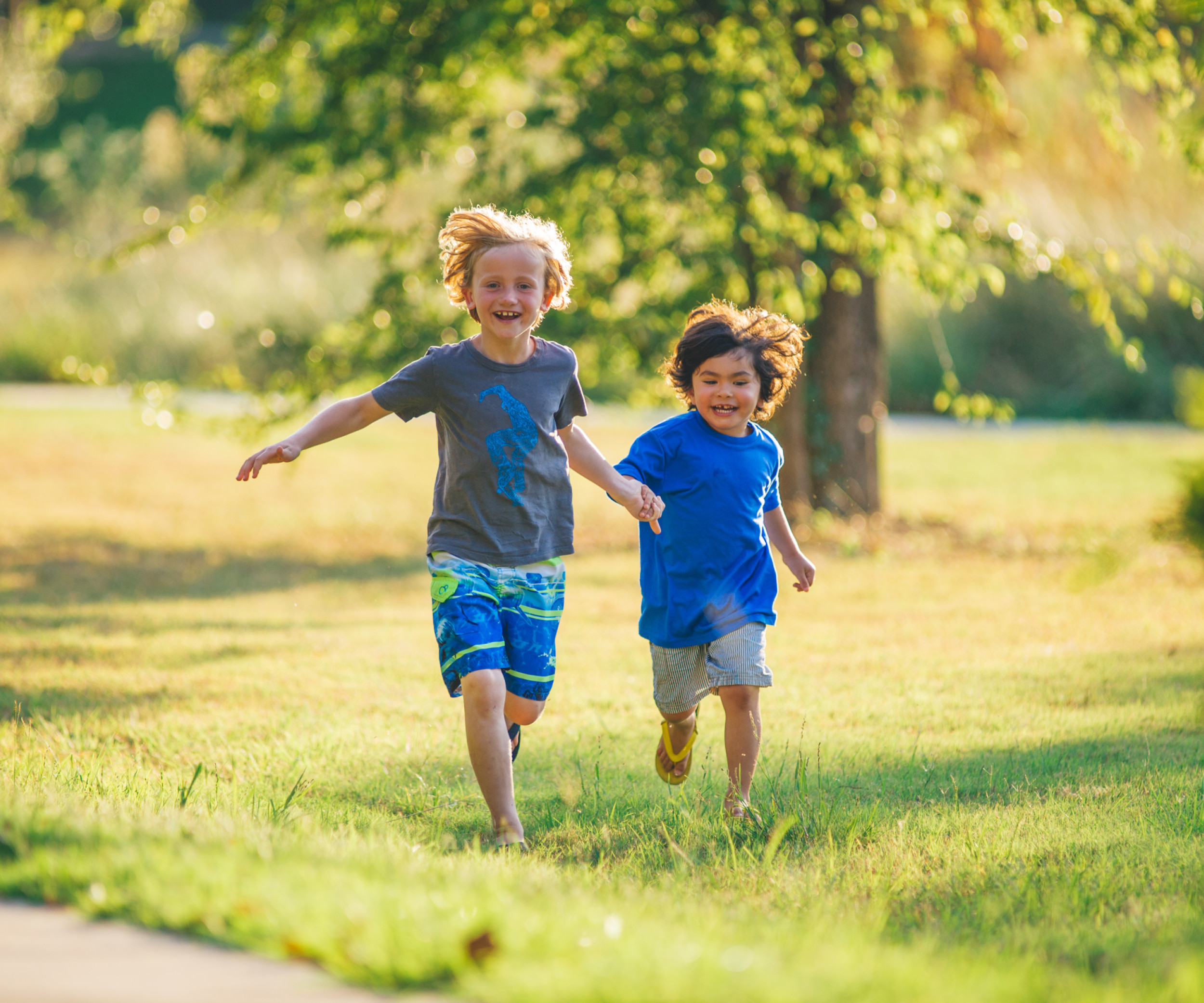 Two kids running in a field